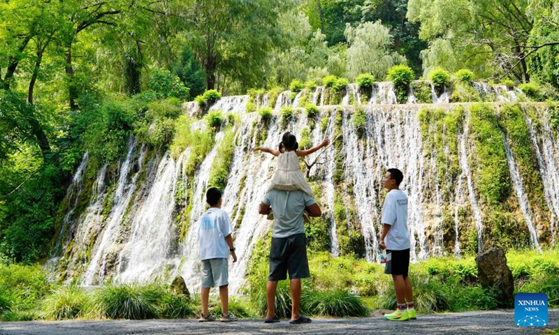 Tourists visit the Huhushui scenic spot in Pingshan County of Shijiazhuang, north China's Hebei Province, July 26, 2026. Shijiazhuang City has leveraged the high-quality mountain and water resources of the Taihang Mountains to develop distinctive cultural tourism experience programs in recent years, attracting a large influx of tourists for summer retreats. (Photo by Yan Zhiguo/Xinhua)