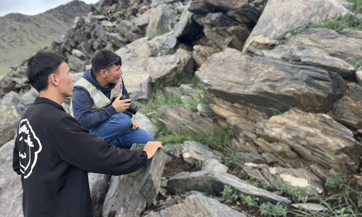 Members of the China-Mongolia joint archaeological team conducts investigation around the newly discovered runic inscription in Bayankhongor Province, Mongolia. Photo: Screenshot from website