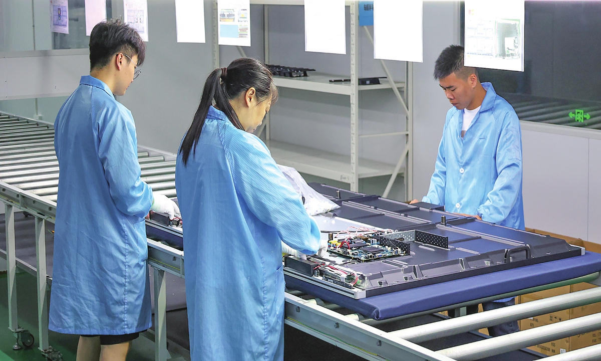 
Workers operate an interactive smart blackboard production line at a company in Lianyungang, East China's Jiangsu Province, on July 27, 2026. In the first half of the year, the accelerated integration of AI across industries drove a sharp rise in computing demand, pushing profits in the electronics sector up 96.9 percent year-on-year. Photo: VCG