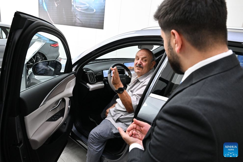 A customer tries a vehicle at a dealership for Chinese automaker BYD in Amman, Jordan, July 21, 2026. As the economic and trade cooperation and cultural exchanges between China and Jordan continue to deepen, a growing number of Chinese elements have found their way into the daily lives of Jordanians. (Xinhua/Xin Mengchen)


