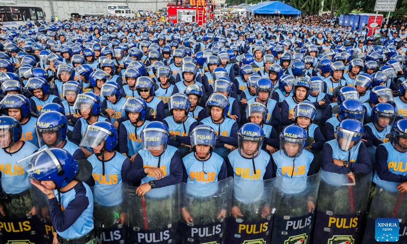 Police officers from the Philippine National Police gather to block the path of protesters during a rally, as President Ferdinand Romualdez Marcos Jr. delivers his 5th State of the Nation Address (SONA) at the House of Representatives, in Quezon City, the Philippines, on July 27, 2026. Various sectors took to the streets to voice their grievances over government policies. (Xinhua/Rouelle Umali)

