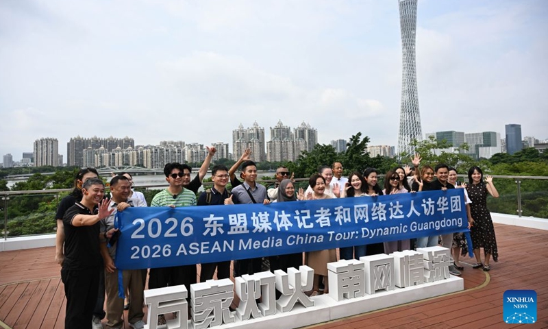 Journalists and social media influencers from ASEAN countries pose for a group photo at a science popularization center of a substation under China Southern Power Grid Co., Ltd. in Guangzhou, south China's Guangdong Province, July 27, 2026.

