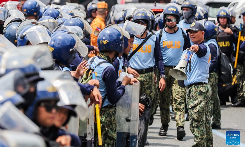 Police officers from the Philippine National Police gather to block the path of protesters during a rally, as President Ferdinand Romualdez Marcos Jr. delivers his 5th State of the Nation Address (SONA) at the House of Representatives, in Quezon City, the Philippines, on July 27, 2026. Various sectors took to the streets to voice their grievances over government policies. (Xinhua/Rouelle Umali)

