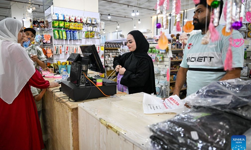 A cashier rings up groceries at a Chinese shopping mall in Aqaba, Jordan, July 24, 2026. As the economic and trade cooperation and cultural exchanges between China and Jordan continue to deepen, a growing number of Chinese elements have found their way into the daily lives of Jordanians. (Xinhua/Xin Mengchen)

