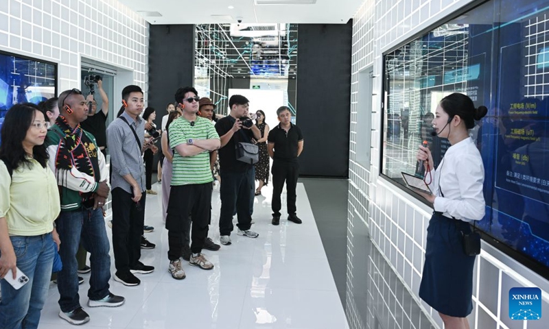 Journalists and social media influencers from ASEAN countries visit a science popularization center of a substation under China Southern Power Grid Co., Ltd. in Guangzhou, south China's Guangdong Province, July 27, 2026.

