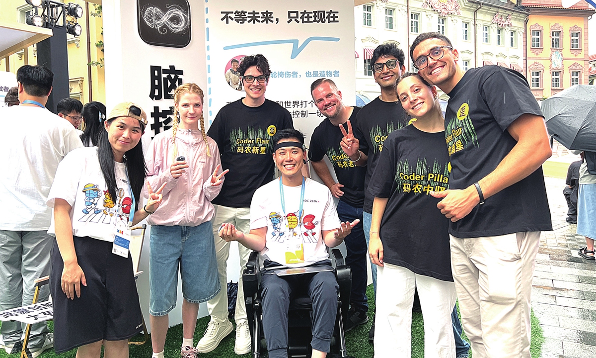 The couple present their brain-controlled wheelchair to a visiting overseas team at the Huawei Developer Conference (HDC) in Dongguan, South China's Guangdong Province, on June 12. The conference was held from June 12 to 14, 2026. Photo: Courtesy of Wang