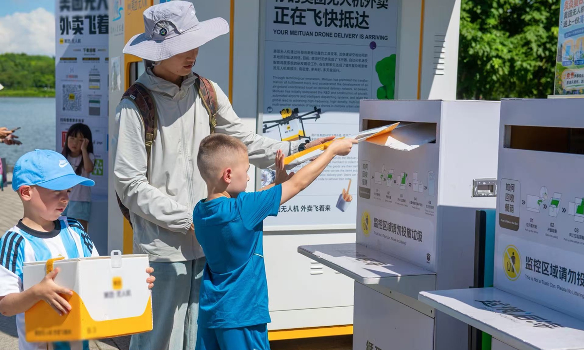 Foreign tourists experience drone delivery services in Shenzhen, South China's Guangdong Province, on June 21, 2026. Photo: VCG