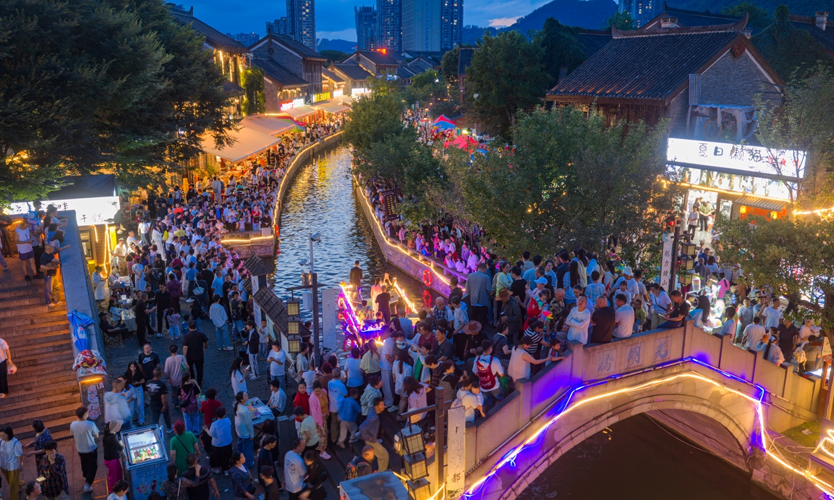 Tourists enjoy themselves at a cultural and gourmet block in Liupanshui, Southwest China's Guizhou Province on July 30, 2026. Leveraging diverse offerings including nighttime dining, evening performances and nightscape leisure activities, the ancient town has become an integrated multi-format block, continuously unleashing consumption vitality. Photo: VCG