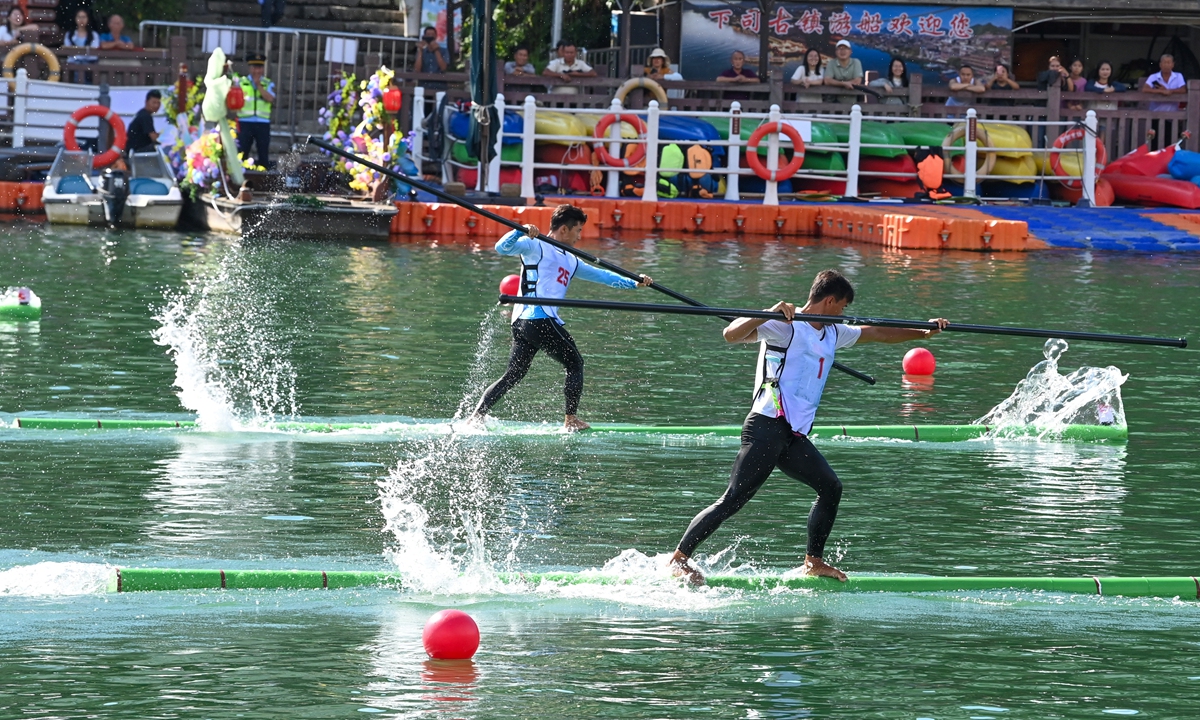 Athletes compete in a single-bamboo drifting contest at the provincial traditional ethnic minorities sports game held in Kaili, Southwest China's Guizhou Province, on July 29, 2026. Photo: VCG