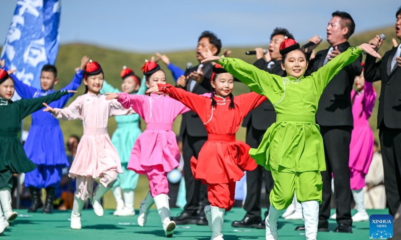 Children give a performance during the opening of a starry grassland tourism season in Xilingol League, north China's Inner Mongolia Autonomous Region, Aug. 1, 2026. A starry grassland tourism season kicked off here on Saturday, featuring nine themed events including starry-sky photography exhibitions and regular stargazing experience sessions. (Xinhua/Lian Zhen)