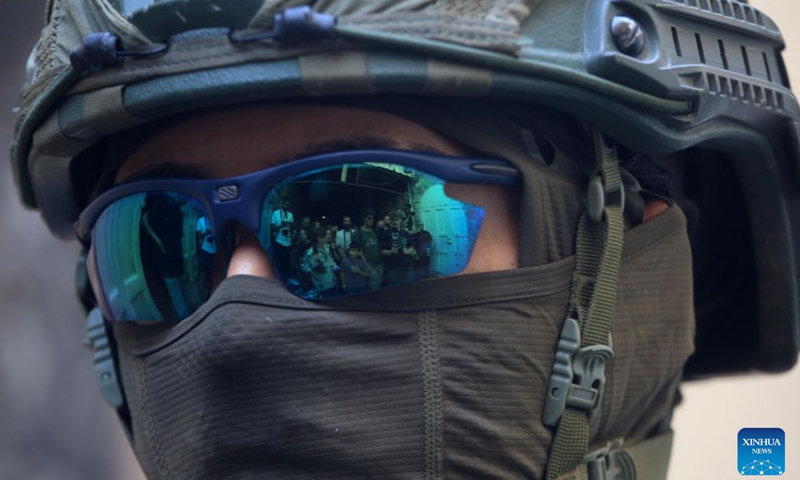 A member of Israeli forces secures the streets for Israeli settlers, in the West Bank city of Hebron, Aug. 1, 2026. Israeli settlers stormed the Old City of Hebron on Saturday, under the protection of the Israeli forces. (Photo by Mamoun Wazwaz/Xinhua)
