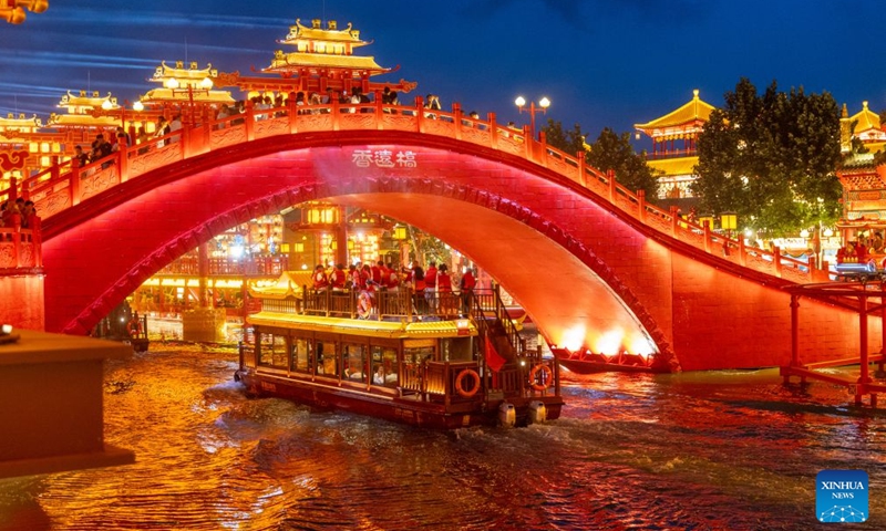 Tourists cruise the Hetou Old Street scenic area in Fengnan District of Tangshan City, north China's Hebei Province, July 31, 2026.
Various performances including light shows and molten iron fireworks are staged here this summer, giving a boost to local tourism consumption. (Photo by Li Xiuqing/Xinhua)