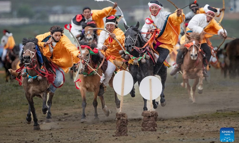 Herdsmen show off equestrian stunts during an equestrian performance event featuring traditional horse-riding skills in Litang County, southwest China's Sichuan Province, on July 31, 2026. (Photo by Xiang Wenjun/Xinhua)