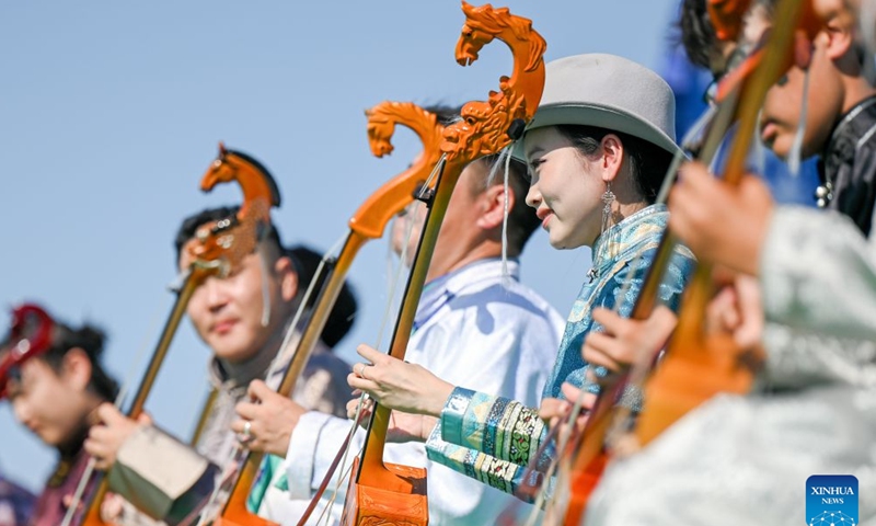 Actors perform Morin Khuur, a traditional Mongolian bowed string instrument featuring a horse-head carving at its top, during the opening of a starry grassland tourism season in Xilingol League, north China's Inner Mongolia Autonomous Region, Aug. 1, 2026. A starry grassland tourism season kicked off here on Saturday, featuring nine themed events including starry-sky photography exhibitions and regular stargazing experience sessions. (Xinhua/Lian Zhen)