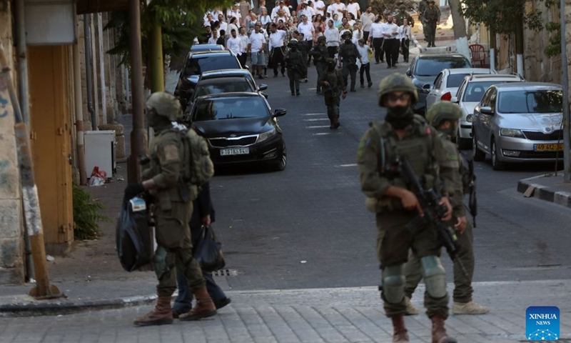 Members of Israeli forces secure the streets for Israeli settlers, in the West Bank city of Hebron, Aug. 1, 2026. Israeli settlers stormed the Old City of Hebron on Saturday, under the protection of the Israeli forces. (Photo by Mamoun Wazwaz/Xinhua)