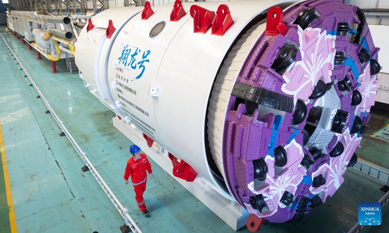 A drone photo taken on Aug. 1, 2026 shows China's first boring and blasting machine at a manufacturing base of China Railway Science & Industry Group in Wuhan, central China's Hubei Province. China's first boring and blasting machine rolled off the production line here on Saturday, filling the gap in integrated tunneling equipment for tunnels with complex geological conditions. (Xinhua/Xiao Yijiu)