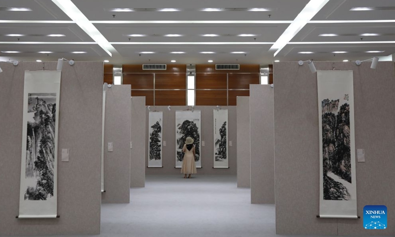 A visitor views exhibits during a traditional Chinese painting exhibition in Beijing, capital of China, Aug. 1, 2026. (Xinhua/Lu Peng)