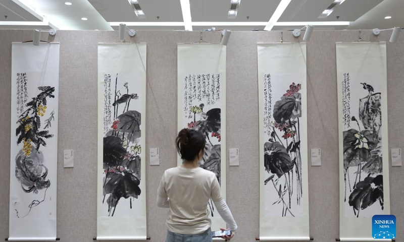 A visitor views exhibits during a traditional Chinese painting exhibition in Beijing, capital of China, Aug. 1, 2026. (Xinhua/Lu Peng)