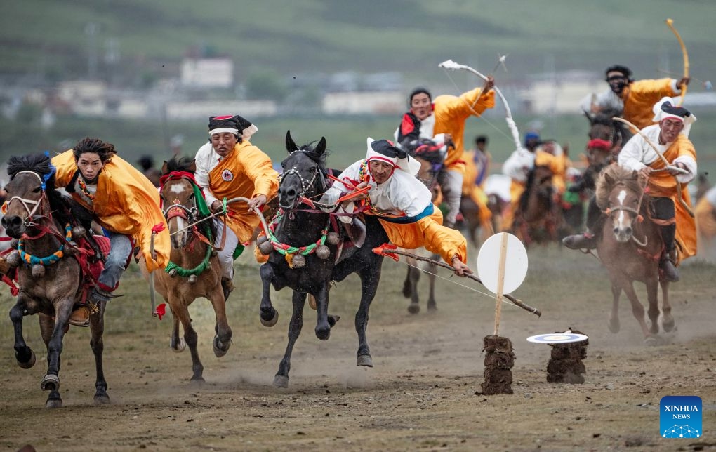 Herdsmen show off equestrian stunts during an equestrian performance event featuring traditional horse-riding skills in Litang County, southwest China's Sichuan Province, on July 31, 2026. (Photo by Xiang Wenjun/Xinhua)
