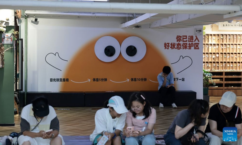People have a rest at the 1905 cultural and creative park in Shenyang, northeast China's Liaoning Province, July 27, 2026. The cultural and creative park in Tiexi District of Shenyang was transformed from an old factory in 2012. It now offers cultural and creative products, artworks, and drama performances, and has since attracted a large number of visitors. It has become a popular gathering place for young people, showcasing the new vitality of cultural consumption in the city. (Xinhua/Li Gang)