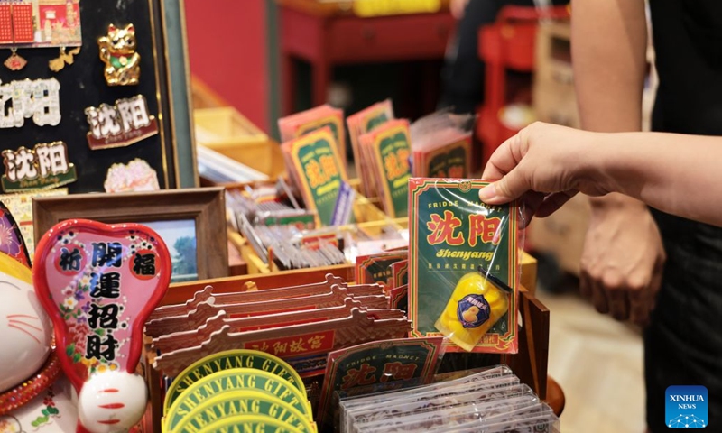 People select fridge magnets at a shop of the 1905 cultural and creative park in Shenyang, northeast China's Liaoning Province, July 27, 2026. The cultural and creative park in Tiexi District of Shenyang was transformed from an old factory in 2012. It now offers cultural and creative products, artworks, and drama performances, and has since attracted a large number of visitors. It has become a popular gathering place for young people, showcasing the new vitality of cultural consumption in the city. (Xinhua/Li Gang)