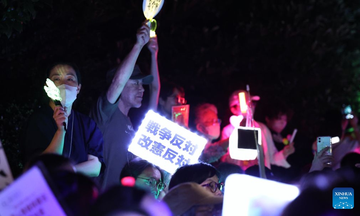 People holding signs attend a protest rally in front of the National Diet Building in Tokyo, Japan, July 10, 2026. A large number of Japanese citizens gathered in front of the National Diet Building in Tokyo on Friday evening to protest a series of dangerous policies and bills recently promoted by the government of Prime Minister Sanae Takaichi. Photo: Xinhua