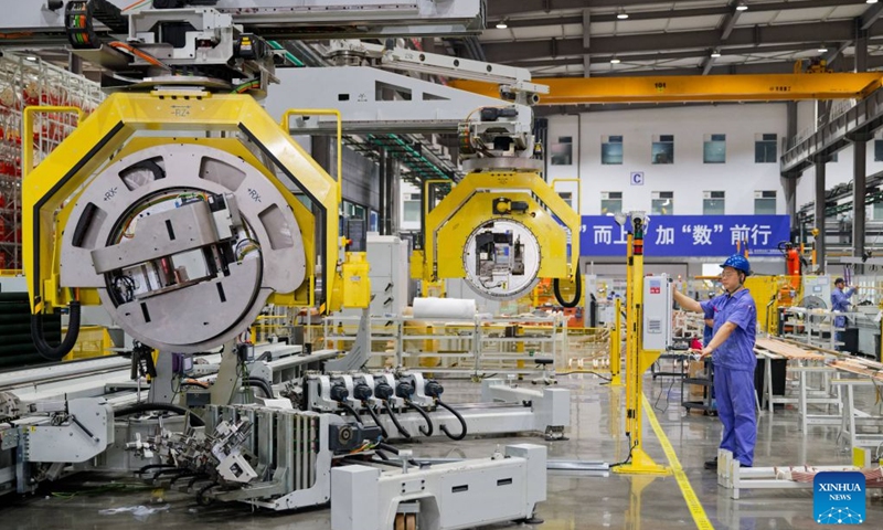 A worker operates an intelligent manufacturing equipment at a workshop of Harbin Electric Machinery Co., Ltd. in Harbin, northeast China's Heilongjiang Province, on July 28, 2026.(Xinhua/Zhang Tao)