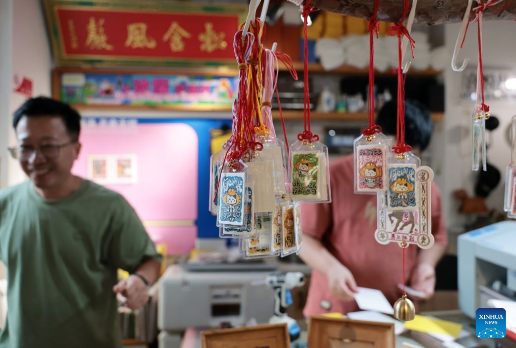 People visit a shop at the 1905 cultural and creative park in Shenyang, northeast China's Liaoning Province, July 27, 2026. The cultural and creative park in Tiexi District of Shenyang was transformed from an old factory in 2012. It now offers cultural and creative products, artworks, and drama performances, and has since attracted a large number of visitors. It has become a popular gathering place for young people, showcasing the new vitality of cultural consumption in the city. (Xinhua/Li Gang)