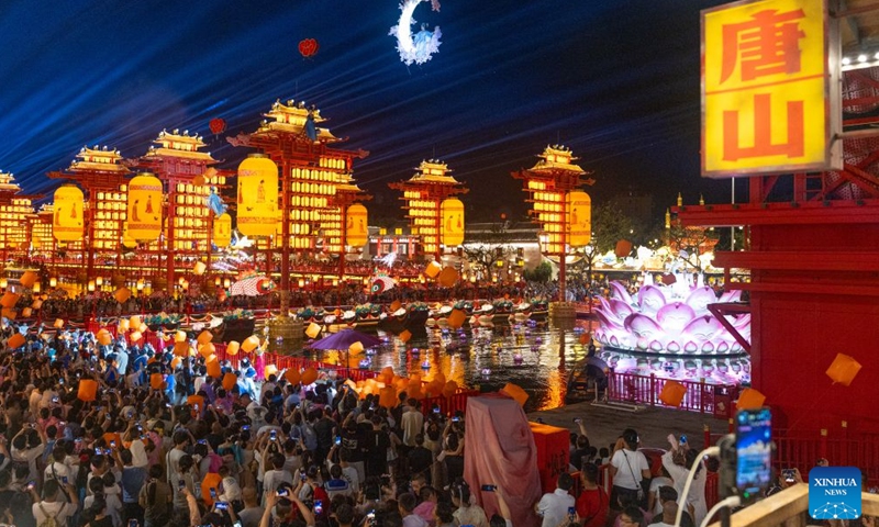 Tourists watch a performance at the Hetou Old Street scenic area in Fengnan District of Tangshan City, north China's Hebei Province, July 31, 2026.
Various performances including light shows and molten iron fireworks are staged here this summer, giving a boost to local tourism consumption. (Photo by Li Xiuqing/Xinhua)