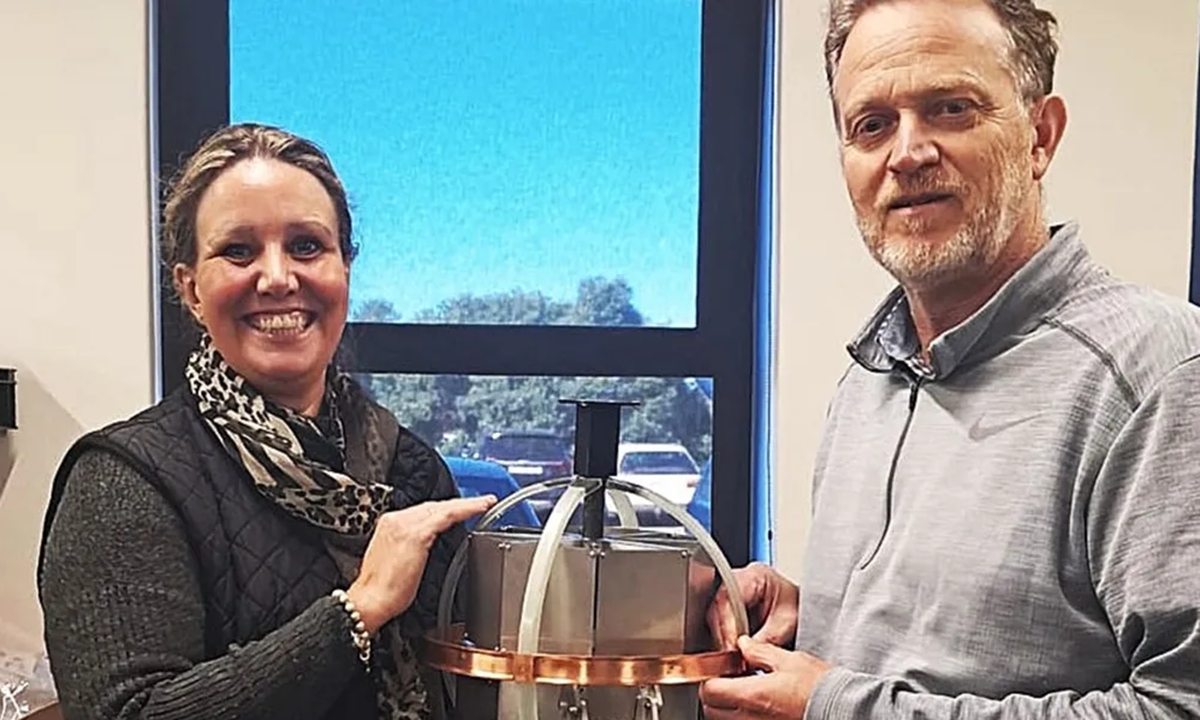 Carla Mitchell (left), mission director for Africa's Bounced African Low Lunar Sphere, and Japie Ludick, South African Radio Astronomy Observatory engineer, with one of the BALLS spheres that underwent testing. Photo: Courtesy of Africa2Moon