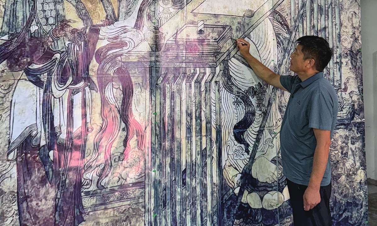Conservators carry out testing on the Buddha statues at the Dazu Rock Carvings site in Chongqing Municipality on June 29, 2019.  Conservation expert Bai Yongqin explores a mural in North China's Shanxi Province. 
Photo: Courtesy of Bai Yongqin