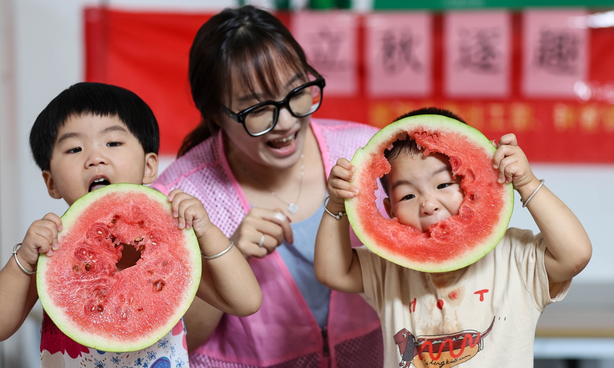Children at a kindergarten in Deqing, East China's Zhejiang Province, eat watermelons to observe the traditional biting?autumn custom on August 6, 2026, greeting the upcoming Start of Autumn solar term, which falls on August 7 this year. Photo: VCG