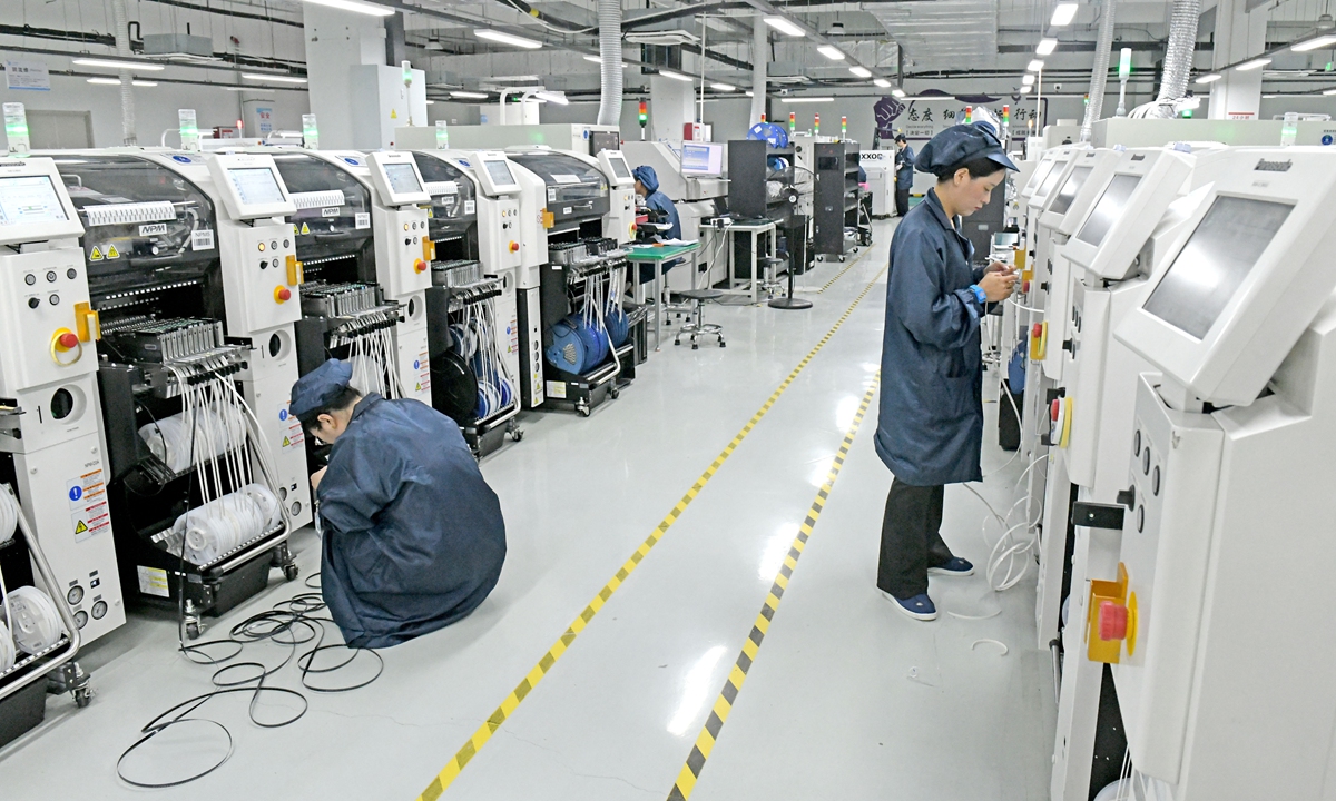 Workers at an information technology company produce computers in the intelligent workshop of a 5G factory in Huainan, East China's Anhui Province, on June 24, 2026. Photo: VCG