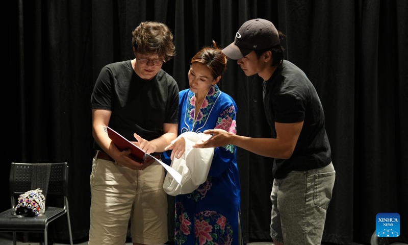 Composer Johannes Grosz (1st L), actress Fiona Zhu (C) and co-director and co-writer Zhang Keyuan discuss during the rehearsal for an original one-woman musical Herstory in History in London, Britain, Aug. 3, 2026. (Photo by Jade Cao/Xinhua)