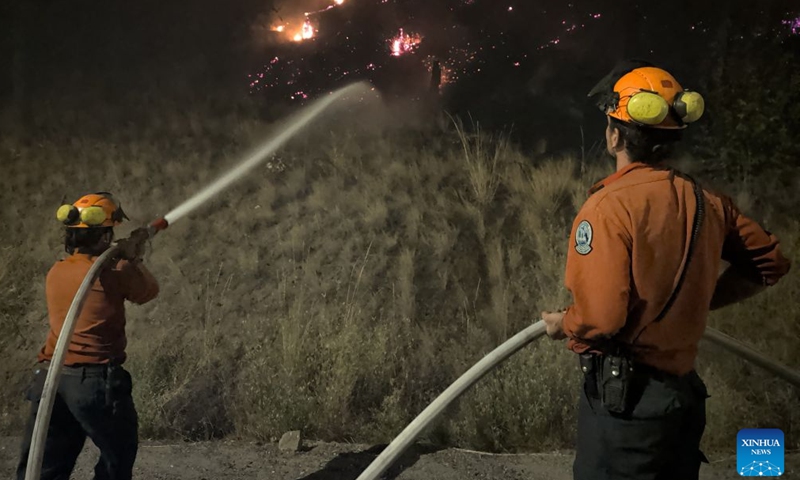 This photo provided by the BC Wildfire Service on Aug. 8, 2026 shows firefighters putting out a wildfire near Okanagan Valley in the Southern Interior of British Columbia, Canada. The western Canadian province of British Columbia (B.C.) declared a provincial state of emergency on Saturday as fast-spreading wildfires threatened several communities. (BC Wildfire Service/Handout via Xinhua)