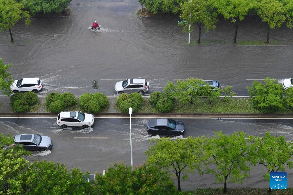 Vehicles drive through a waterlogged street in Wuxi, east China's Jiangsu Province, Aug. 10, 2026. Typhoon Dolphin is moving inland after making two landfalls along the coast of east China's Zhejiang Province and is expected to bring heavy precipitation to more than 10 provincial-level regions, according to China's National Meteorological Center on Monday. (Photo: Xinhua)