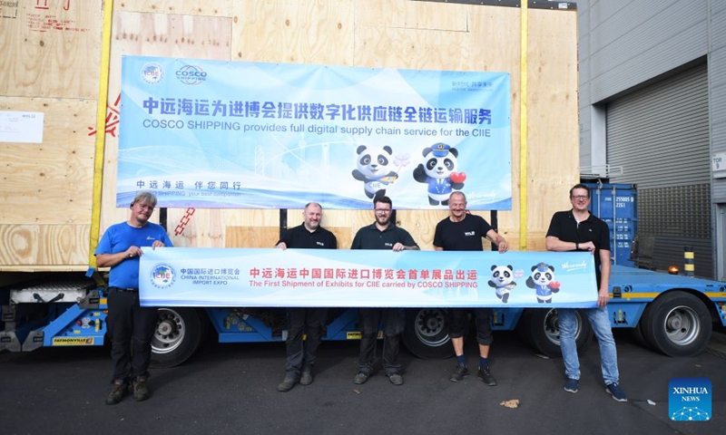 Staff members pose for a group photo with exhibit products of WFL Millturn Technologies to be shipped in Linz, Austria, Aug. 7, 2026. Exhibit products from WFL Millturn Technologies in Linz, Austria, began their journey to Shanghai on Friday, marking the shipment of the first batch of exhibits for the 9th China International Import Expo (CIIE) this year.