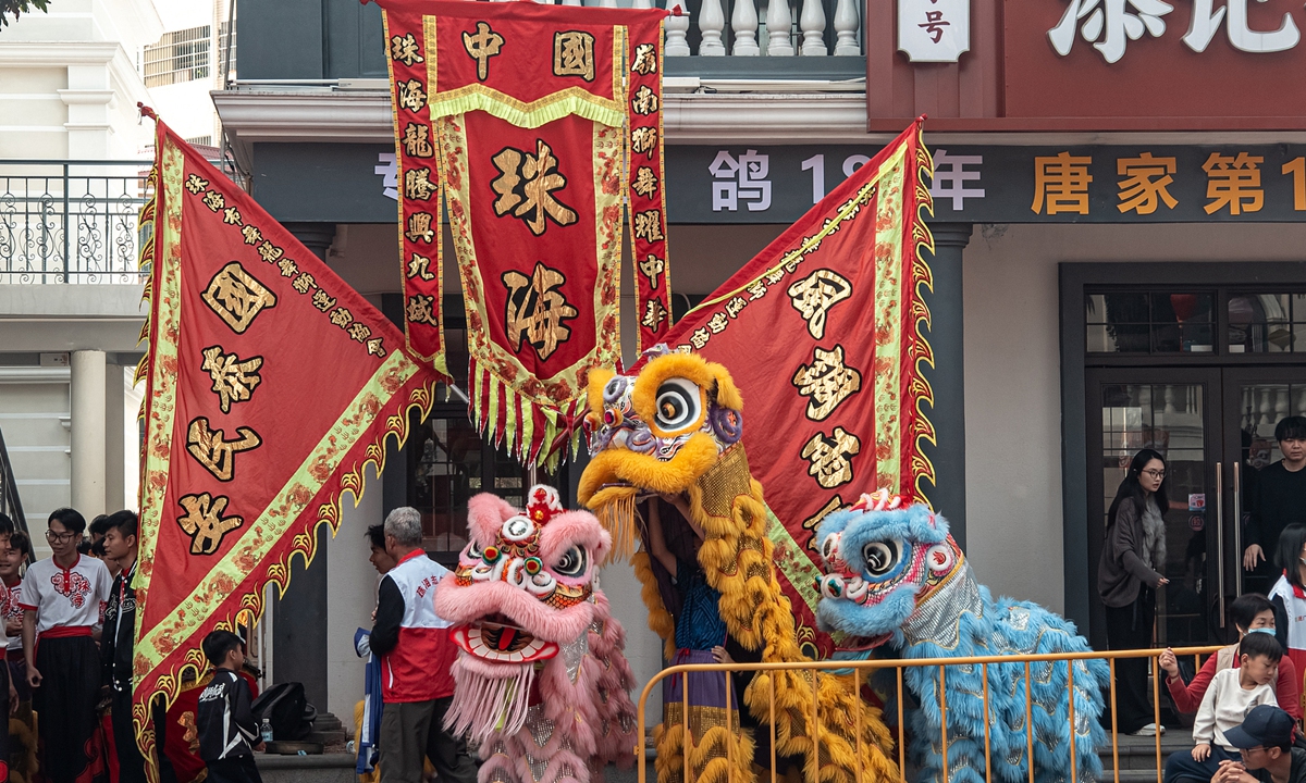 A lion dance is performed at Tangjiawan ancient town in Guangdong Province. 