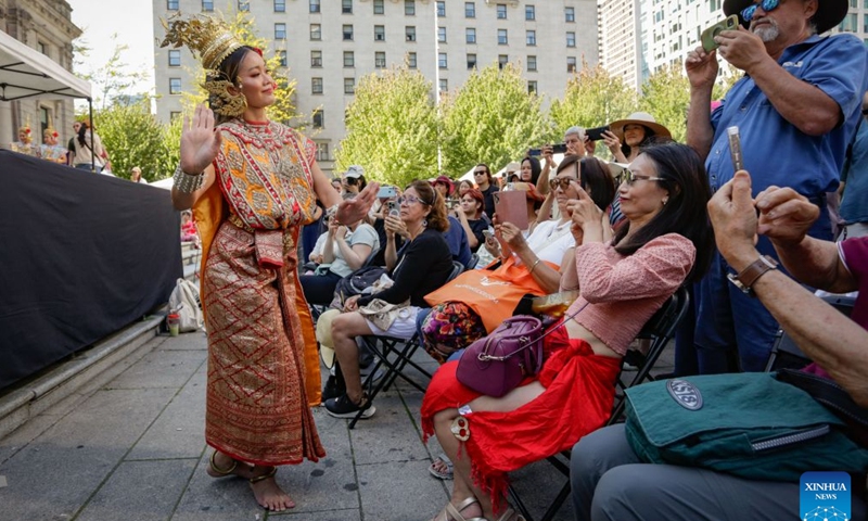 A performer presents traditional Thai dance during the 2026 Thai Festival in Vancouver, British Columbia, Canada, Aug. 8, 2026. The annual Thai Festival featured traditional food, music, dance, crafts and cultural performances, highlighting Thailand's rich and vibrant culture. (Photo by Liang Sen/Xinhua)