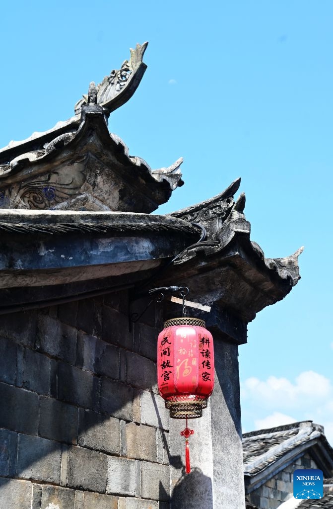 A lantern is hung under an upturned swallow-tail roof ridge at Peitian Village, Xuanhe Town, Liancheng County, Longyan City, southeast China's Fujian Province, Aug. 6, 2026.