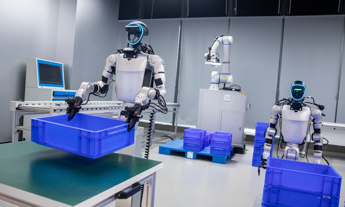 Robots conduct logistics and warehousing scenario training at an embodied intelligence exhibition center in Hangzhou, East China's Zhejiang Province, on June 11, 2026. Photo: VCG