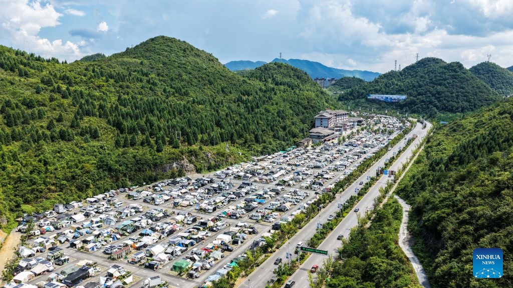 An aerial drone photo shows RVs from across the country parking at an RV camping base in Bijie, southwest China's Guizhou Province, Aug. 11, 2026. The cool climate and rich tourism resources in Guizhou have attracted lots of visitors seeking a summer retreat. (Photo: Xinhua)