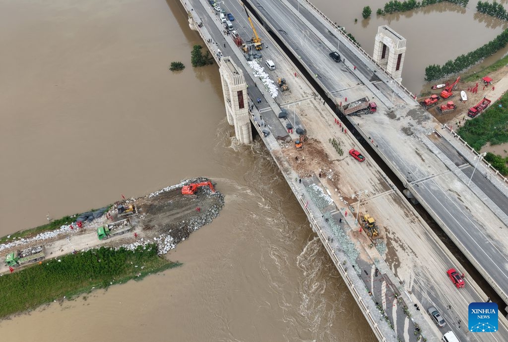 An aerial drone photo take on Aug. 15, 2026 shows repair work underway at the site of a levee breach along the Jialu River in Chuanhui District of Zhoukou City, central China's Henan Province. Around 11 p.m. on Thursday, a breach occurred on the east bank embankment of the Jialu River below a bridge in Chuanhui District of Zhoukou City, due to pressure of upstream inflow from the Jialu River and backflow from the Shaying River,. (Photo: Xinhua)