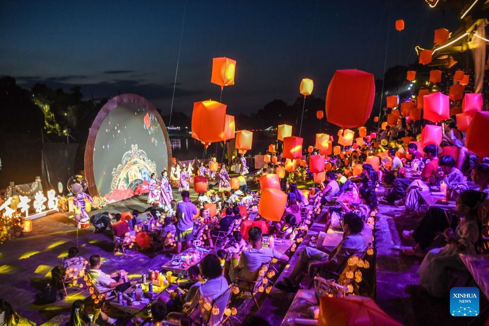 People enjoy a performance at a concert held during a tourism and culture festival themed on floating lanterns for the Qixi Festival, also known as Chinese Valentine's Day, in Rongchang District of southwest China's Chongqing Municipality, Aug. 15, 2026. The tourism and culture festival kicked off here on Saturday, featuring a concert, a parade and various performances including molten iron fireworks and bamboo raft shows. (Photo: Xinhua)