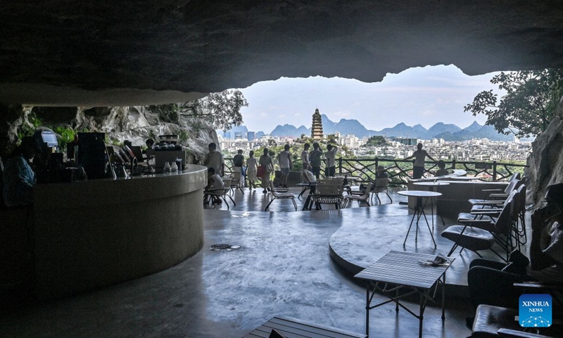 Tourists enjoy scenery inside a cave in Guilin, south China's Guangxi Zhuang Autonomous Region, Aug. 12, 2026. In recent years, Guangxi has tapped the tourism potential of its caves, developing them into popular attractions while ensuring visitor safety. (Photo: Xinhua)