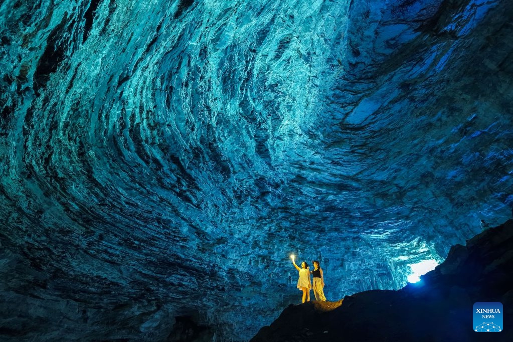 Tourists visit a cave in Guilin, south China's Guangxi Zhuang Autonomous Region, Aug. 12, 2026. In recent years, Guangxi has tapped the tourism potential of its caves, developing them into popular attractions while ensuring visitor safety. (Photo: Xinhua)