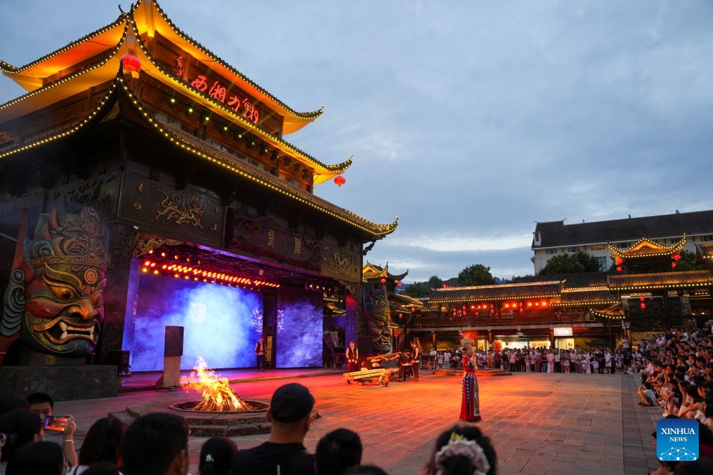 The Charming Xiangxi show is staged in Zhangjiajie, central China's Hunan Province, Aug. 14, 2026. Leveraging its rich intangible cultural heritage, the city of Zhangjiajie has developed diverse summer getaways and multiple forms of night tours, fueling a travel boom during the peak season. (Photo: Xinhua)