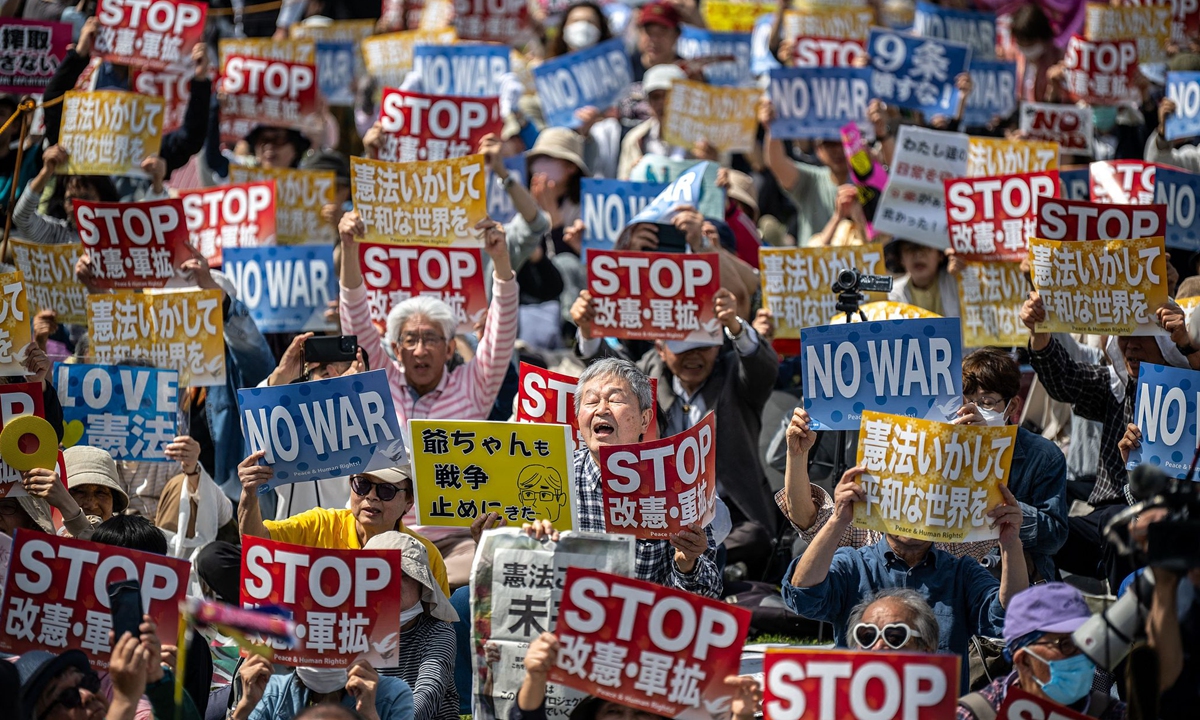 People hold placards reading 