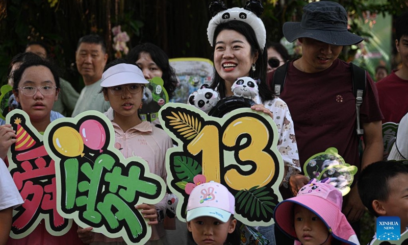 Tourists participate in the birthday celebration for giant panda brothers Gong Gong and Shun Shun at Hainan Tropical Wildlife Park and Botanical Garden in Haikou, south China's Hainan Province, Aug. 15, 2026. Hainan Tropical Wildlife Park and Botanical Garden held a 13th birthday celebration for giant panda brothers Gong Gong and Shun Shun on Saturday. They were born in 2013 at the Bifengxia panda base in Ya'an, southwest China's Sichuan Province, and were transferred here in 2018. (Photo: Xinhua)