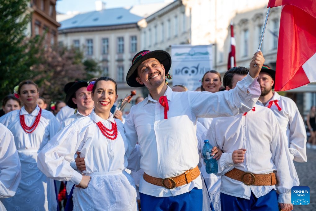People take part in a parade during the Summer Folklore Festival in Prague, the Czech Republic, Aug. 15, 2026. The Summer Folklore Festival was held in Prague on Saturday, bringing together international folklore ensembles presenting their traditional dances, music and costumes. (Photo: Xinhua)